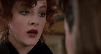 Movie still from “Broadcast News” (1987), directed by James L. Brooks – A person with curly red hair; Close Up shot, Over the shoulder angle