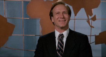 Movie still from “Broadcast News” (1987), directed by James L. Brooks – A man wearing a suit and tie smiling for the camera; Close Up shot, Low angle