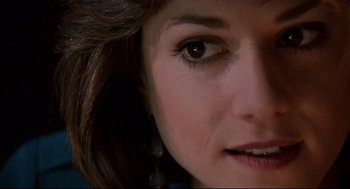 Movie still from “Broadcast News” (1987), directed by James L. Brooks – A woman's face with brown eyes; Close Up shot, Over the shoulder angle