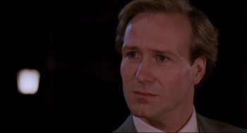 Movie still from “Broadcast News” (1987), directed by James L. Brooks – A person wearing a suit and tie; Close Up shot, Over the shoulder angle