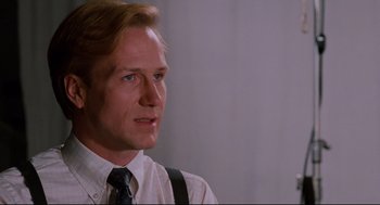 Movie still from “Broadcast News” (1987), directed by James L. Brooks – A person wearing a shirt and a tie; Close Up shot, Low angle