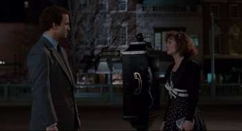Movie still from “Broadcast News” (1987), directed by James L. Brooks – A man and a woman standing next to each other; Medium shot, Low angle