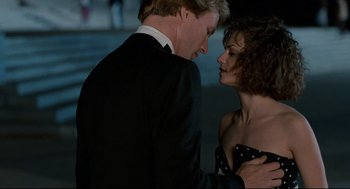 Movie still from “Broadcast News” (1987), directed by James L. Brooks – A man and a woman are dancing together; Close Up shot, Over the shoulder angle