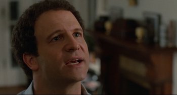 Movie still from “Broadcast News” (1987), directed by James L. Brooks – A man's face in a living room; Close Up shot, Over the shoulder angle