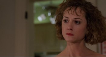Movie still from “Broadcast News” (1987), directed by James L. Brooks – A person with short curly hair; Close Up shot, Over the shoulder angle