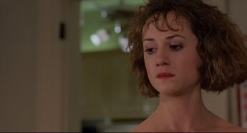 Movie still from “Broadcast News” (1987), directed by James L. Brooks – A person with short curly hair; Close Up shot, Over the shoulder angle