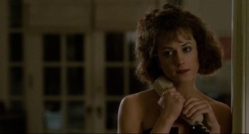 Movie still from “Broadcast News” (1987), directed by James L. Brooks – A woman holding a phone up to her ear; Close Up shot, Over the shoulder angle