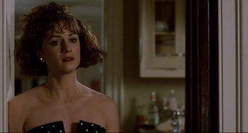 Movie still from “Broadcast News” (1987), directed by James L. Brooks – A woman in a polka dot dress standing in a kitchen; Close Up shot, Over the shoulder angle