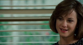 Movie still from “Broadcast News” (1987), directed by James L. Brooks – A person with short brown hair; Close Up shot, Over the shoulder angle