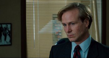 Movie still from “Broadcast News” (1987), directed by James L. Brooks – A person wearing a suit and tie; Close Up shot, Over the shoulder angle