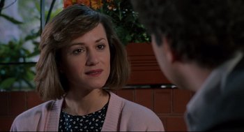 Movie still from “Broadcast News” (1987), directed by James L. Brooks – A woman in a black and white shirt and a man in a pink sweater; Close Up shot, Over the shoulder angle
