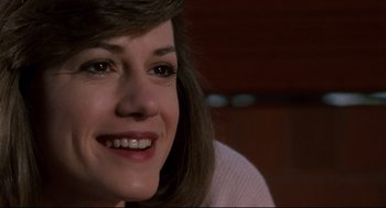 Movie still from “Broadcast News” (1987), directed by James L. Brooks – A person with a smile on their face; Close Up shot, Over the shoulder angle