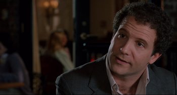 Movie still from “Broadcast News” (1987), directed by James L. Brooks – A person wearing a suit and tie; Close Up shot, Over the shoulder angle