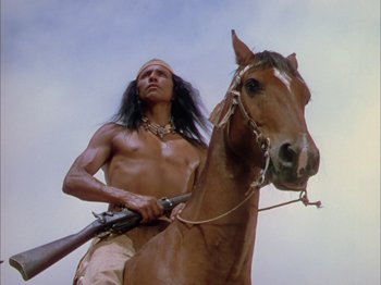 Movie still from “Broken Arrow” (1950), directed by Delmer Daves – A man is sitting on the back of a brown horse; Medium shot, Low angle