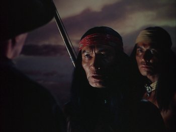 Movie still from “Broken Arrow” (1950), directed by Delmer Daves – Two native american men in traditional clothing and headgear; Close Up shot, Low angle
