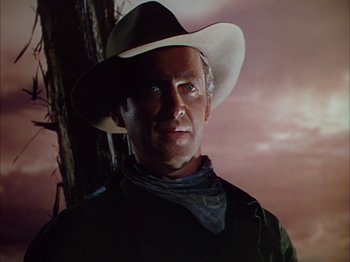 Movie still from “Broken Arrow” (1950), directed by Delmer Daves – A man wearing a cowboy hat standing next to a tree; Close Up shot, Low angle