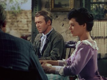 Movie still from “Broken Arrow” (1950), directed by Delmer Daves – A man and a woman sitting at a table; Medium shot, Over the shoulder angle