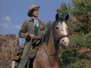 Movie still from “Broken Arrow” (1950), directed by Delmer Daves – A man riding on the back of a brown horse; Medium shot, Low angle