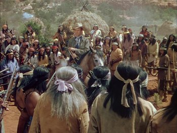 Movie still from “Broken Arrow” (1950), directed by Delmer Daves – A group of people gathered around a man on a horse; Wide shot, High angle