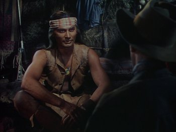 Movie still from “Broken Arrow” (1950), directed by Delmer Daves – A man in a native american outfit talking to a man in a cowboy hat; Medium shot, Over the shoulder angle
