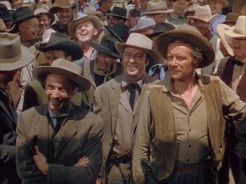 Movie still from “Broken Arrow” (1950), directed by Delmer Daves – A large group of men wearing hats and suits; Medium shot, Low angle