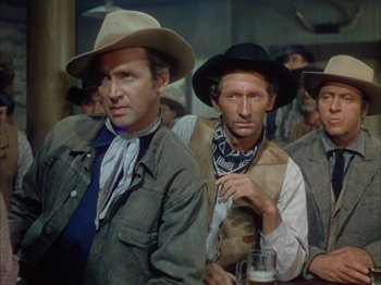 Movie still from “Broken Arrow” (1950), directed by Delmer Daves – A group of men standing next to each other in a room; Medium shot, Low angle