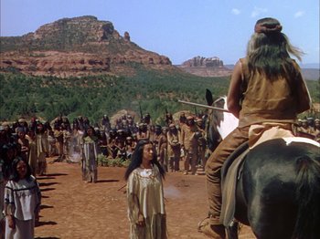 Movie still from “Broken Arrow” (1950), directed by Delmer Daves – A group of native americans gathered in the desert; Wide shot, Over the shoulder angle