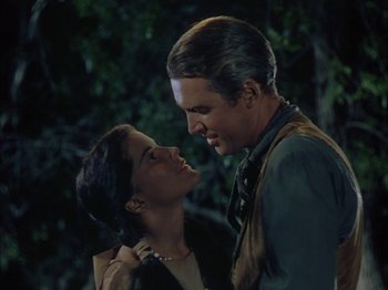 Movie still from “Broken Arrow” (1950), directed by Delmer Daves – A man and a woman standing next to each other in front of a tree; Close Up shot, Low angle