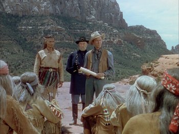 Movie still from “Broken Arrow” (1950), directed by Delmer Daves – A group of men standing next to each other on top of a hill; Wide shot, Over the shoulder angle