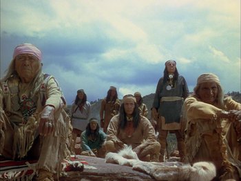 Movie still from “Broken Arrow” (1950), directed by Delmer Daves – A group of native american men and women in traditional clothing; Wide shot, Low angle