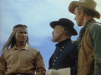 Movie still from “Broken Arrow” (1950), directed by Delmer Daves – A group of men standing next to each other on top of a hill; Medium shot, Over the shoulder angle