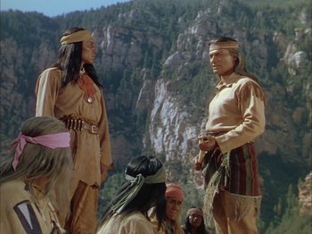 Movie still from “Broken Arrow” (1950), directed by Delmer Daves – A group of native americans standing in front of a mountain; Wide shot, Over the shoulder angle