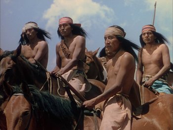 Movie still from “Broken Arrow” (1950), directed by Delmer Daves – A group of native american men riding on horses; Medium shot, Low angle
