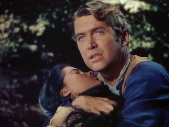 Movie still from “Broken Arrow” (1950), directed by Delmer Daves – A man holding a woman in his arms in a forest; Close Up shot, Over the shoulder angle