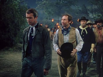 Movie still from “Broken Arrow” (1950), directed by Delmer Daves – A group of men walking down a dirt road; Medium shot, Over the shoulder angle