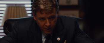 Movie still from “Broken City” (2013), directed by Allen Hughes – A person wearing a suit and tie; Close Up shot, Low angle