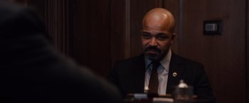 Movie still from “Broken City” (2013), directed by Allen Hughes – A man in a suit and tie sitting in front of a mirror; Close Up shot, Over the shoulder angle