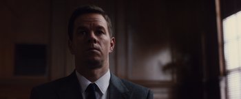 Movie still from “Broken City” (2013), directed by Allen Hughes – A person wearing a suit and tie; Close Up shot, Low angle