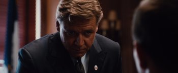 Movie still from “Broken City” (2013), directed by Allen Hughes – A person wearing a suit and tie; Close Up shot, Low angle
