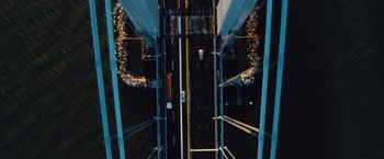 Movie still from “Broken City” (2013), directed by Allen Hughes – An overhead view of a highway with a car on it; Extreme Wide shot, Overhead angle