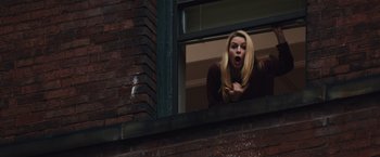 Movie still from “Broken City” (2013), directed by Allen Hughes – A woman is looking out of a window; Medium shot, Low angle