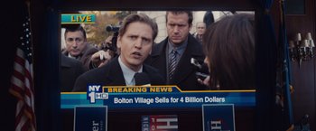 Movie still from “Broken City” (2013), directed by Allen Hughes – A television screen showing a news story with a man talking to a woman; Close Up shot, Over the shoulder angle