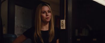 Movie still from “Broken City” (2013), directed by Allen Hughes – A beautiful young lady standing in front of a door; Close Up shot, Over the shoulder angle