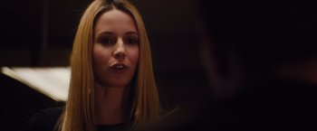 Movie still from “Broken City” (2013), directed by Allen Hughes – A woman with long blonde hair is looking at the camera; Close Up shot, Over the shoulder angle