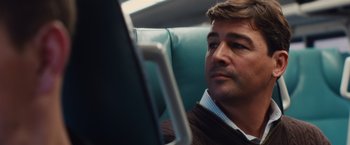 Movie still from “Broken City” (2013), directed by Allen Hughes – A person sitting on a bus; Close Up shot, Over the shoulder angle