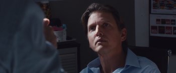 Movie still from “Broken City” (2013), directed by Allen Hughes – A person looking at a camera; Close Up shot, Over the shoulder angle