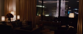 Movie still from “Broken City” (2013), directed by Allen Hughes – A living room with a view of a city at night time; Extreme Wide shot, High angle