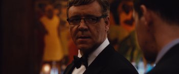 Movie still from “Broken City” (2013), directed by Allen Hughes – A person wearing a suit and tie; Close Up shot, Over the shoulder angle