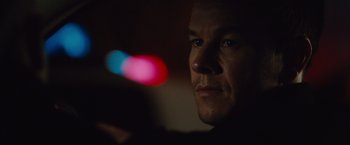 Movie still from “Broken City” (2013), directed by Allen Hughes – A man's face in the dark; Close Up shot, Low angle