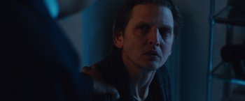 Movie still from “Broken City” (2013), directed by Allen Hughes – A person with long hair looking at the camera; Close Up shot, Over the shoulder angle